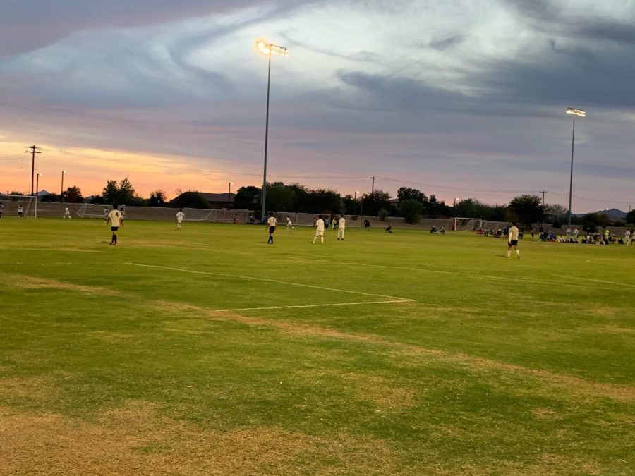 A soccer game takes place at dusk in Arizona, where club sports are permitted to compete.