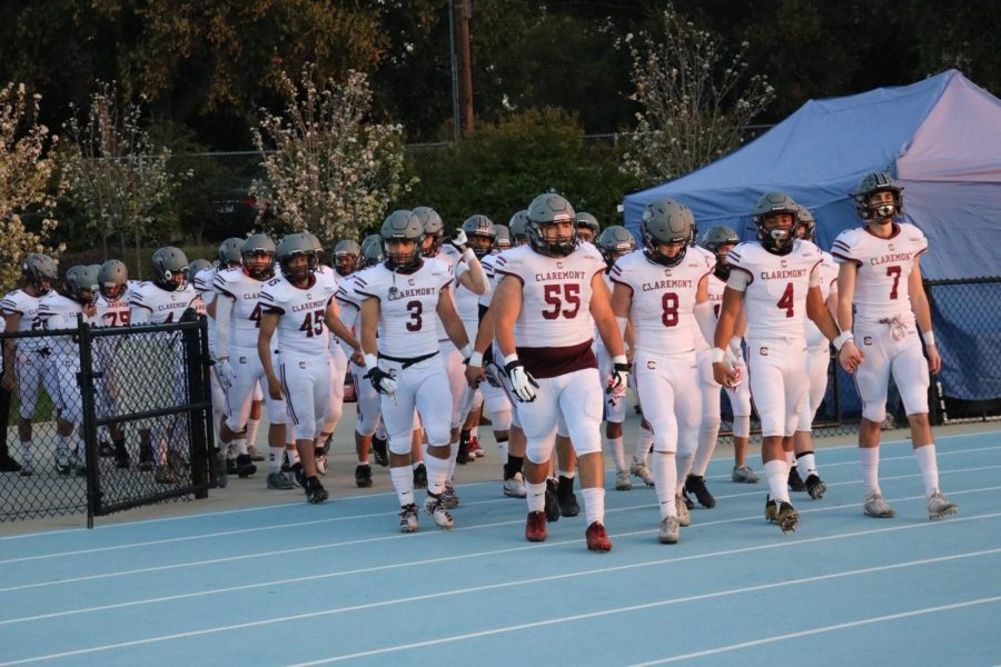 The team walks onto the field at an away game.